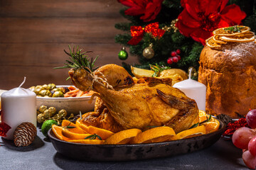 Christmas or New Year dinner foods on dark table. Set of traditional Xmas party dishes - pannetone,...