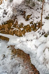 Winter landscape with snow-covered trees, a river in the forest
