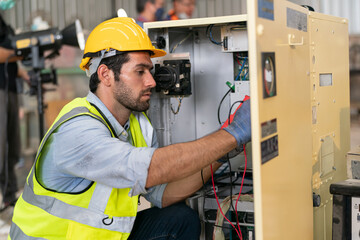 Robotics engineer working on maintenance of modern robotic arm in factory warehouse