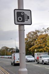 Speed camera sign on a main road in England reminding drivers to watch their speed.