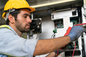 Robotics engineer working on maintenance of modern robotic arm in factory warehouse