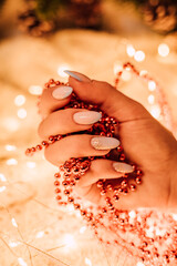 Christmas composition. Women's hands with red beads