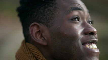 Fototapeta na wymiar Smiling happy black african man portrait face close-up