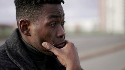 Fototapeta premium Stressed ou black African man feeling neck pain due to emotional struggle