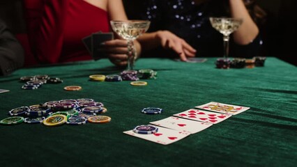 Extreme close-up of poker cards, player checking his hand before making bet. Casino customer playing at table, winning combination strategy, gambling fortune. Lucky tournament winner looking at pair