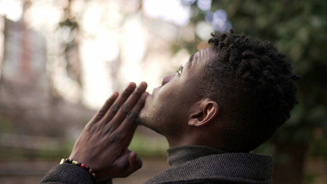 Religious young black man praying to God. African person looking up at sky with HOPE and FAITH2