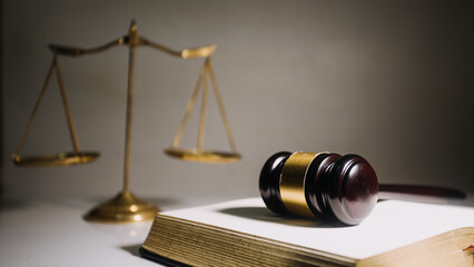 Business and lawyers discussing contract papers with brass scale on desk in office. Law, legal services, advice, justice and law concept