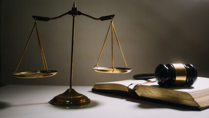 Business and lawyers discussing contract papers with brass scale on desk in office. Law, legal services, advice, justice and law concept