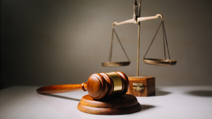 Business and lawyers discussing contract papers with brass scale on desk in office. Law, legal services, advice, justice and law concept