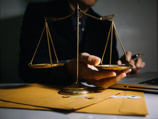 Business and lawyers discussing contract papers with brass scale on desk in office. Law, legal services, advice, justice and law concept