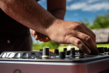 Dick Jockey equipment in night club, CD turntable and mixing equipment, speakers and amplifiers. Hands of DJ over the turntable in the night club