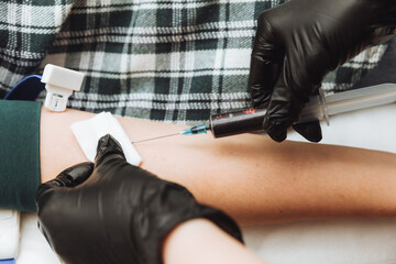 A medical technologist who provides blood collection services for a patient. a person donates blood from a vein