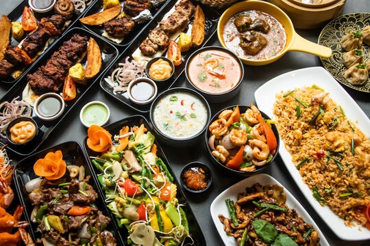 Assorted south indian food, Mutton Brain Masala, Chicken Tangdi, Chicken Reshmi tikka, Chicken karahi, Beef Nehari , Beef Bihari kabab, Beef tikka Boti, Garlic Naan aand lachha paratha isolated