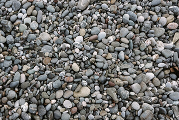 Abstract background with black and gray round sea pebble stones