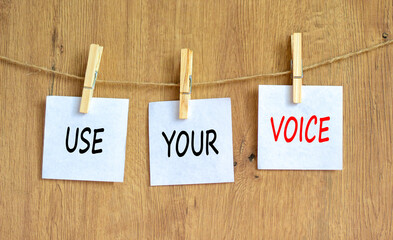 Use your voice symbol. Concept words Use your voice on white paper on a beautiful wooden table...