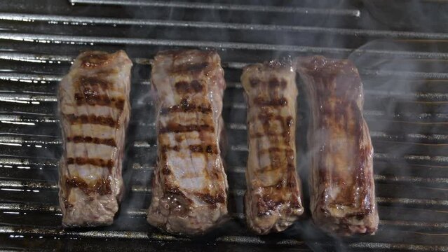Beef steaks cooking at domestic grill