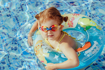 Little girl having fun in swimming pool.