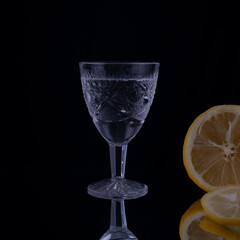 vintage crystal shot glass of vodka on black background