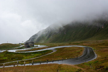 curvy road in the mountains, covered by cloud