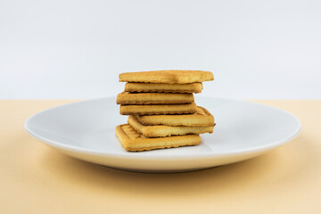 square cookies and crackers in a white plate