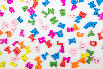 Colorful random wooden letters background.