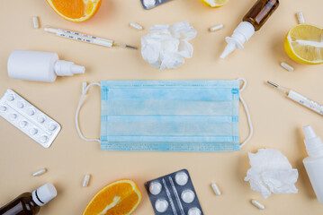 The concept of seasonal diseases. Top view photo of medicine spray and syrup bottle pills capsules...