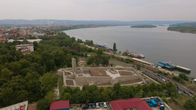 Aerial view of Medieval Citadel of Severin in Drobeta-Turnu Severin city, Romania. Footage was shot from a drone while flying backwards from the citadel on the Romanian bank of Danube river.