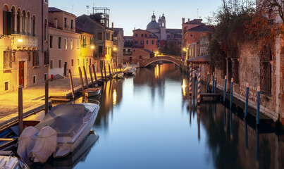 Traditional Venetian houses with the old town along the canal at dawn.