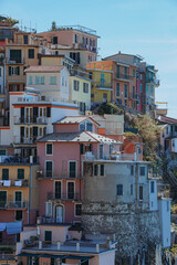 Fototapeta na wymiar The small town of Manarola, Italy, One of the Cinque Terre villages and one of the most famous views in Italy, during an autumn day - October 2022.