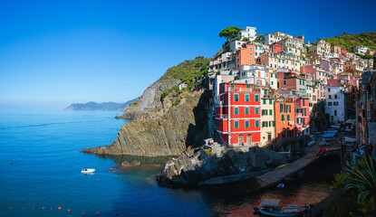 Fototapeta na wymiar The village of Riomaggiore, Italy, one of the five towns of the Cinque Terre, during an autumn morning - October 2022.