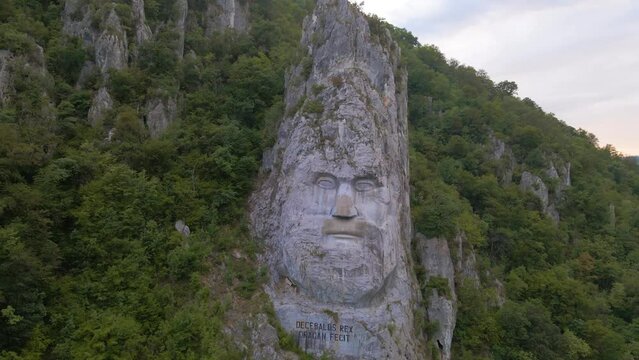 Aerial video of the statue of Decebal, located on the gorges of Danube river in Romania. Video was shoot from a drone with camera lowered with the statue in the view.