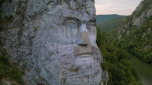 Aerial video of the statue of Decebal, located on the gorges of Danube river in Romania. Video was shoot from a drone with camera lowered with the statue in the view.