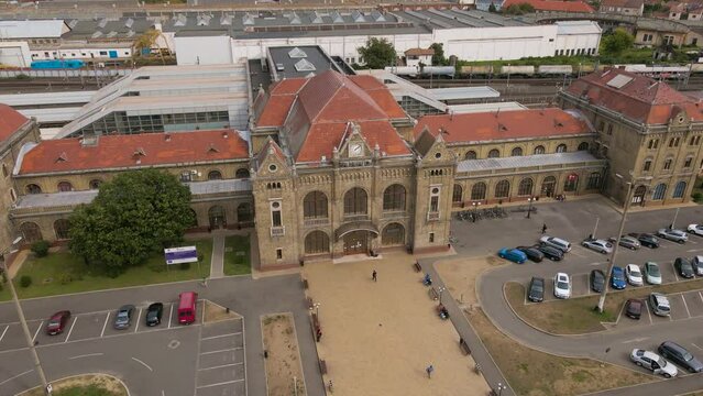 Aerial view of the train station in Arad city, Romania. Footage was shot from a drone while lowering  altitude and flying backwards and rising the camera gimbal.