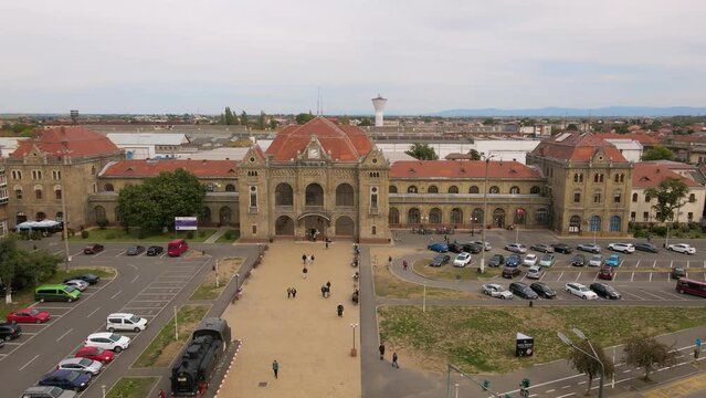 Aerial view of the train station in Arad city, Romania. Footage was shot from a drone at a lower altitude while flying forward and banking left.