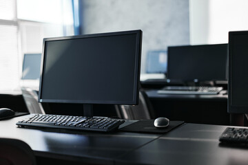 Modern computer monitor and keyboard for work in office room
