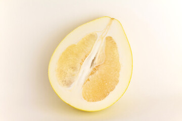 Fototapeta na wymiar Close up ripe juicy fresh cut sliced yellow Pomelo on white color background. Shaddock, citrus maxima, tropical fruit. Top view. Flat lay. 