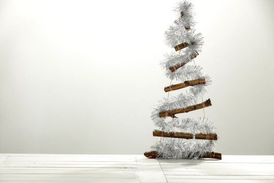 Modern natural Christmas tree on a wooden table and free space