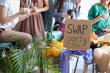 Young women at swap party. Casual clothes, shoes, hats, bags, jewellery. Idea of exchange your old...