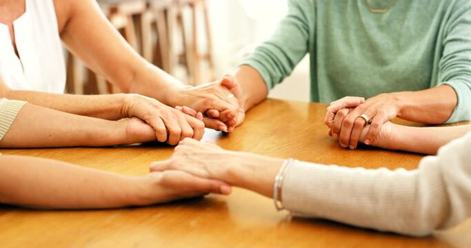 Family hands, faith and Christian prayer group of people or friends with hope, religion and trust or respect. Together, helping and love community with support, solidarity and teamwork at a table
