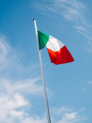 Italian flag in the wind. Italy sky. Italian flag in the sky