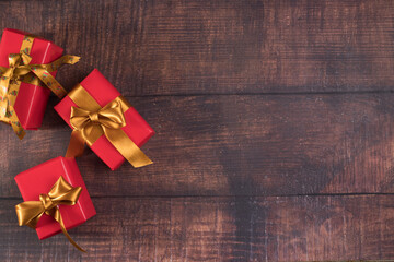 Three gift boxes on wooden table background