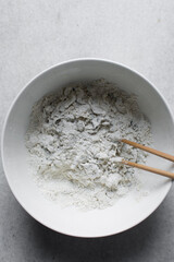 Dry noodles dough, homemade herbed noodles, process of making noodles, dough in white bowl	