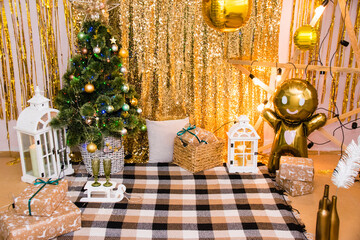 Christmas, New Year interior with golden balloons, garland and New Year decor and gifts under decorated Christmas tree