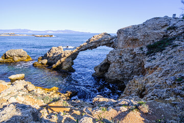 stone arch on the mediterranean coast of spain, near barcelona.