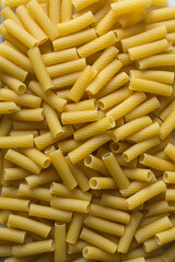 Flat lat of uncooked tortiglioni pasta shells, top view of tortiglioni pasta shells, dry uncooked macaroni