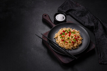 Delicious fresh noodles with sweet pepper, tomato, spices and herbs
