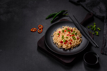 Delicious fresh noodles with sweet pepper, tomato, spices and herbs