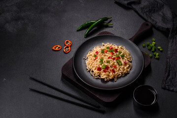 Delicious fresh noodles with sweet pepper, tomato, spices and herbs