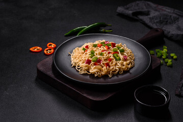 Delicious fresh noodles with sweet pepper, tomato, spices and herbs