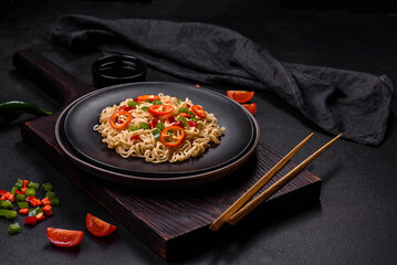 Delicious fresh noodles with sweet pepper, tomato, spices and herbs